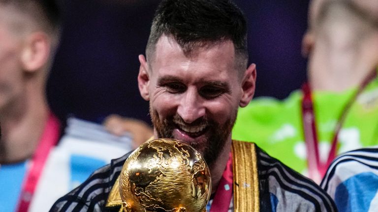 Messi with the best player award in the final and the World Cup gold trophy